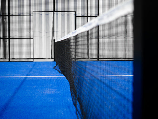 A net on a blue padel court.